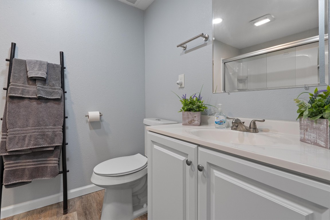 1102 Beech Street Taylor, TX 76574 - Photo 13 of 40 a bathroom with a sink a toilet and a mirror