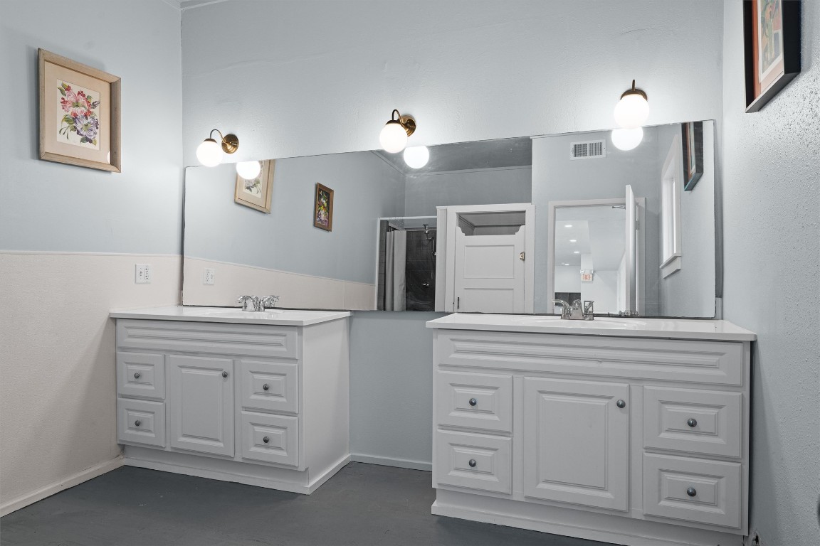 1102 Beech Street Taylor, TX 76574 - Photo 23 of 40 a bathroom with a sink vanity and a mirror