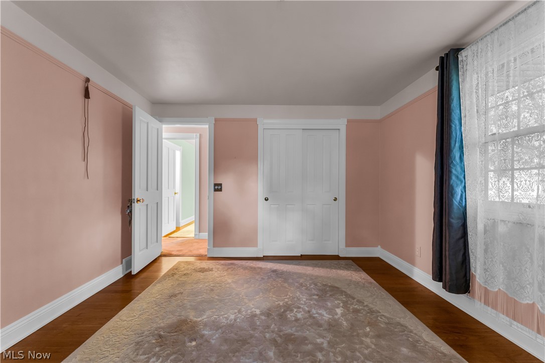 9897 West Ridge Road Elyria, OH 44035 - Photo 20 of 43 Bedroom featuring a closet and dark hardwood / wood-style flooring