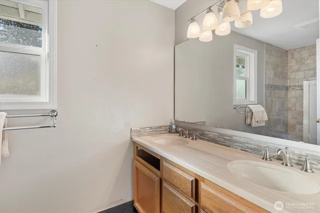 a bathroom with a sink a mirror and a light fixture