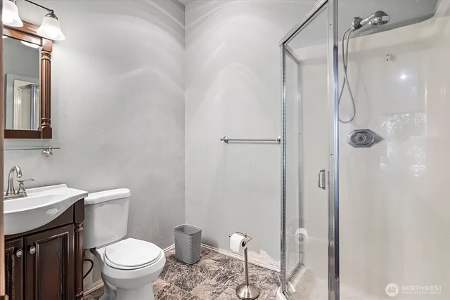 a bathroom with a toilet a sink and shower