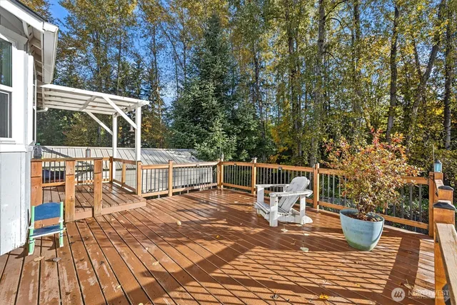 a view of a chairs and table on the wooden deck