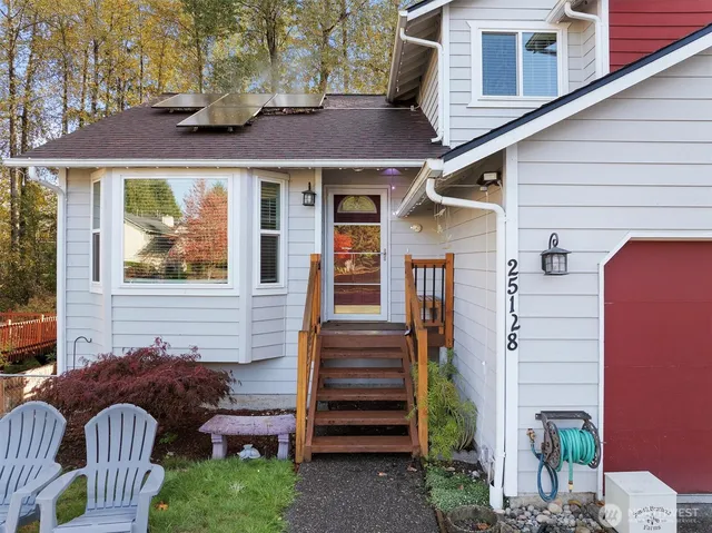 a view of a house with a chairs in patio