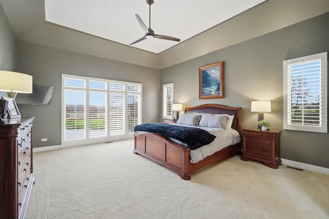 a bedroom with a bed and painting on the wall