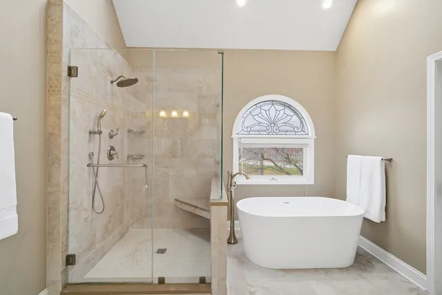 a bathroom with a granite countertop toilet sink and mirror