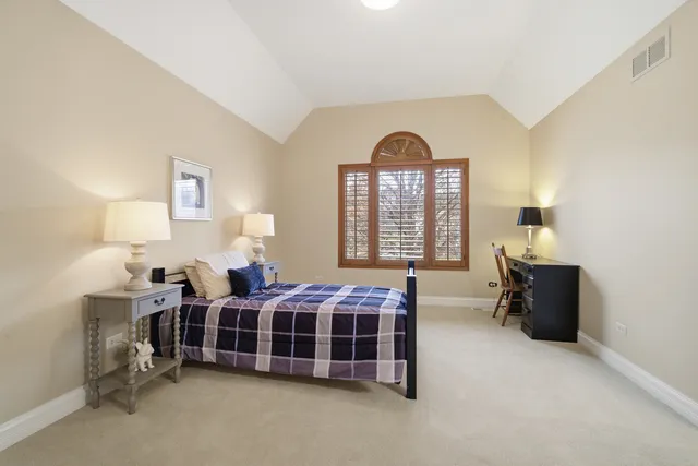 a bathroom with a granite countertop sink a mirror a bathtub and shower