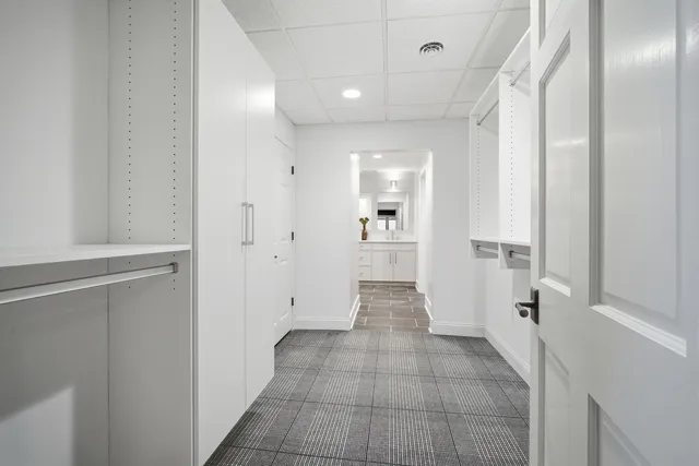 a kitchen with stainless steel appliances granite countertop a sink a refrigerator and cabinets