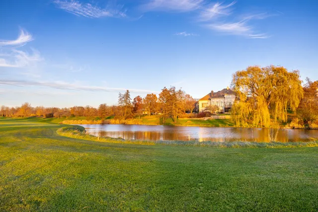 a view of a balcony with wooden floor and fence