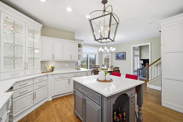 a kitchen with stainless steel appliances granite countertop a sink a stove and refrigerator