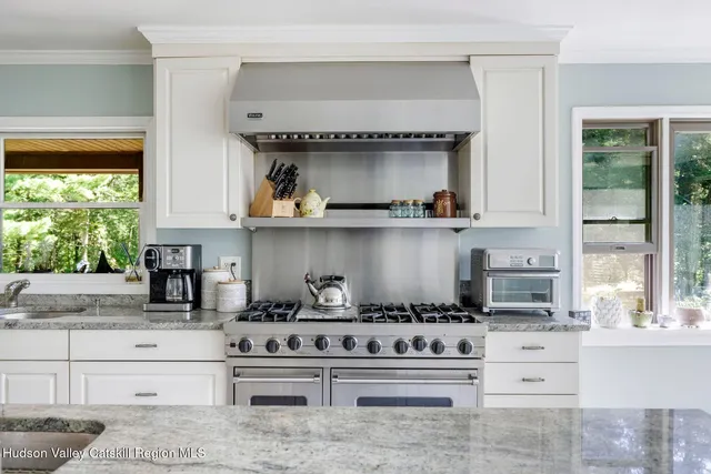 a view of a dining room with furniture large windows and outside view