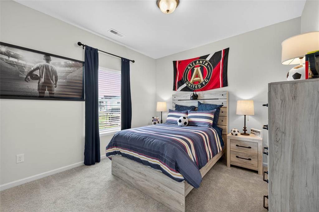 532 Guy Williams Road Rock Spring, GA 30739 - Photo 20 of 42 a bedroom with a bed and painting on the wall