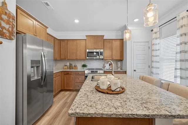 a kitchen with sink refrigerator and stove