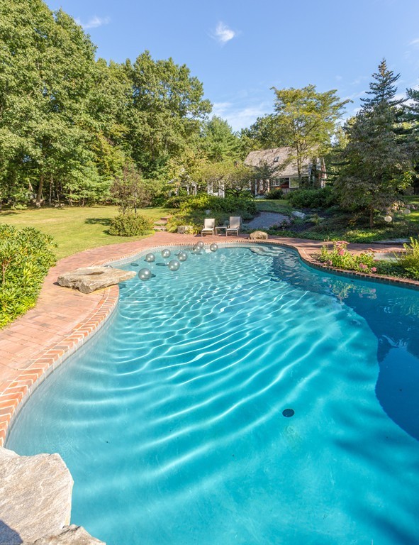 32 Century Mill Road Bolton, MA 01740 - Photo 5 of 27 a view of a swimming pool with an outdoor space and seating area