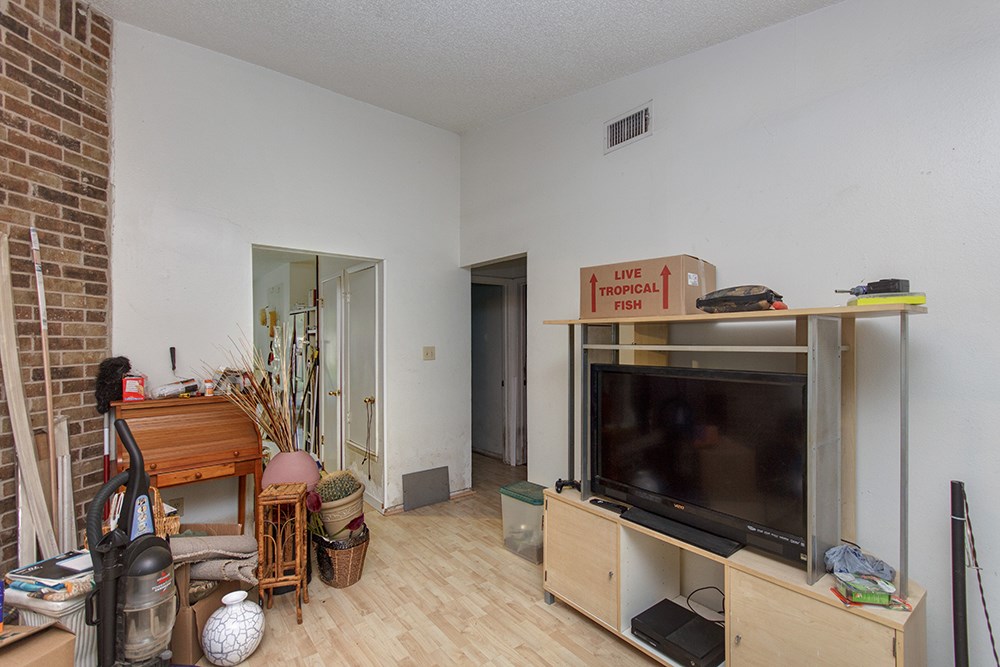 4600 Rocking Chair Road Austin, TX 78744 - Photo 1 of 1 a living room with furniture a flat screen tv and white appliances
