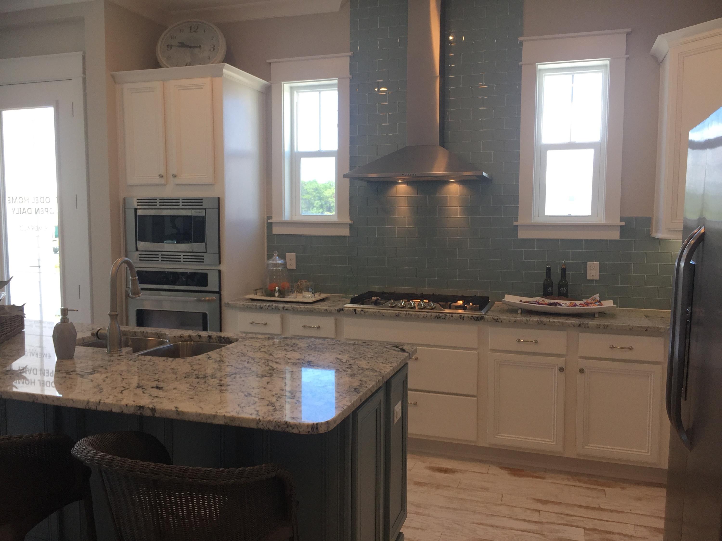 88 Pine Lands Loop Inlet Beach, Unit E A Inlet Beach, FL 32461 - Photo 2 of 11 a kitchen with stainless steel appliances granite countertop a sink stove and cabinets