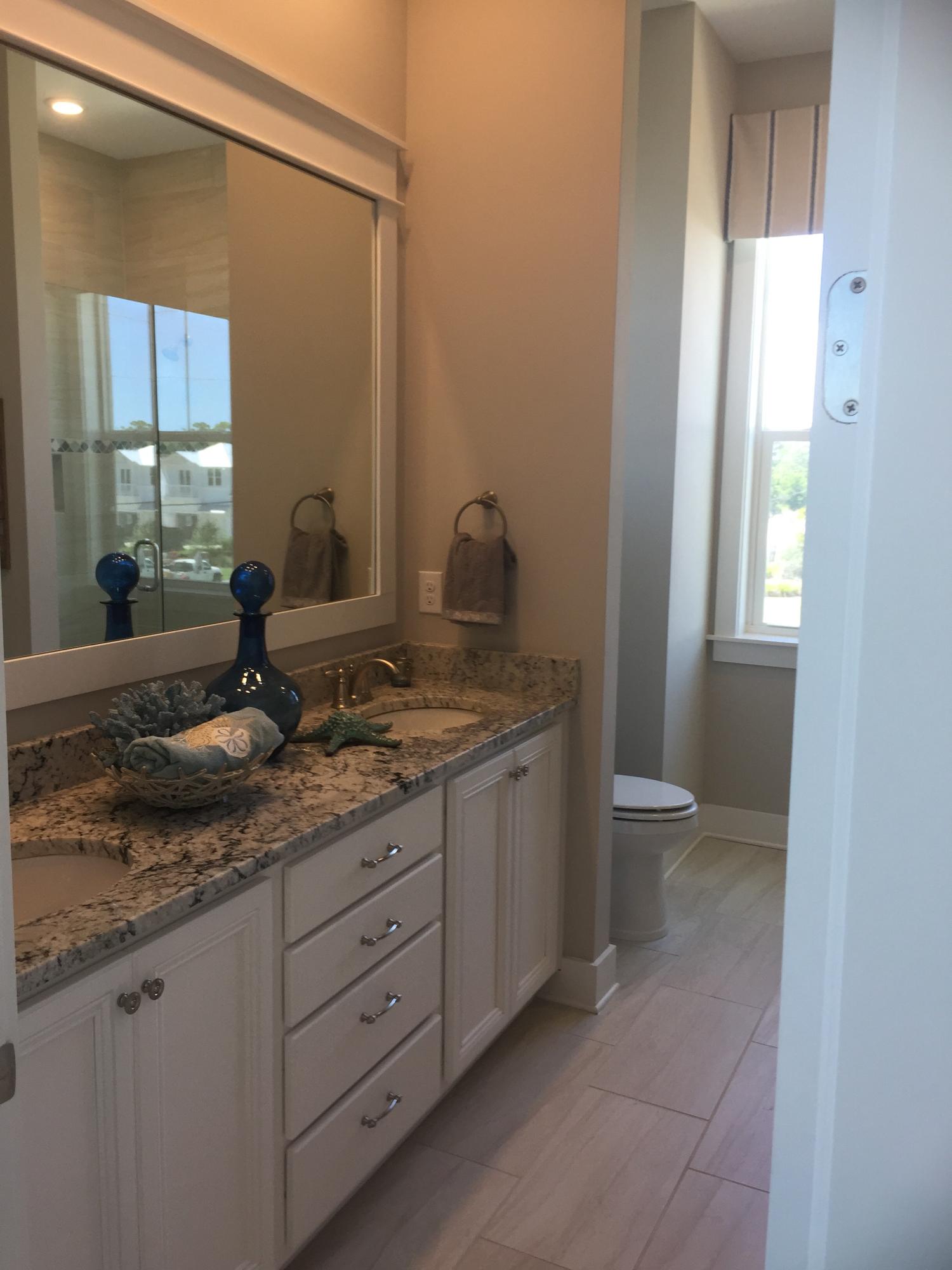 88 Pine Lands Loop Inlet Beach, Unit E A Inlet Beach, FL 32461 - Photo 4 of 11 a bathroom with a granite countertop sink and a mirror