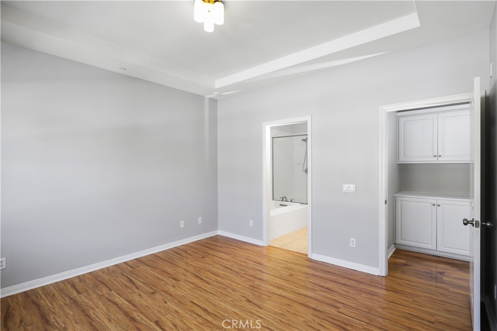 10 Nature Irvine, CA 92620 - Photo 17 of 27 a view of an empty room with wooden floor and a window