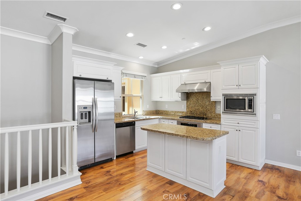 10 Nature Irvine, CA 92620 - Photo 5 of 27 a kitchen with cabinets and stainless steel appliances