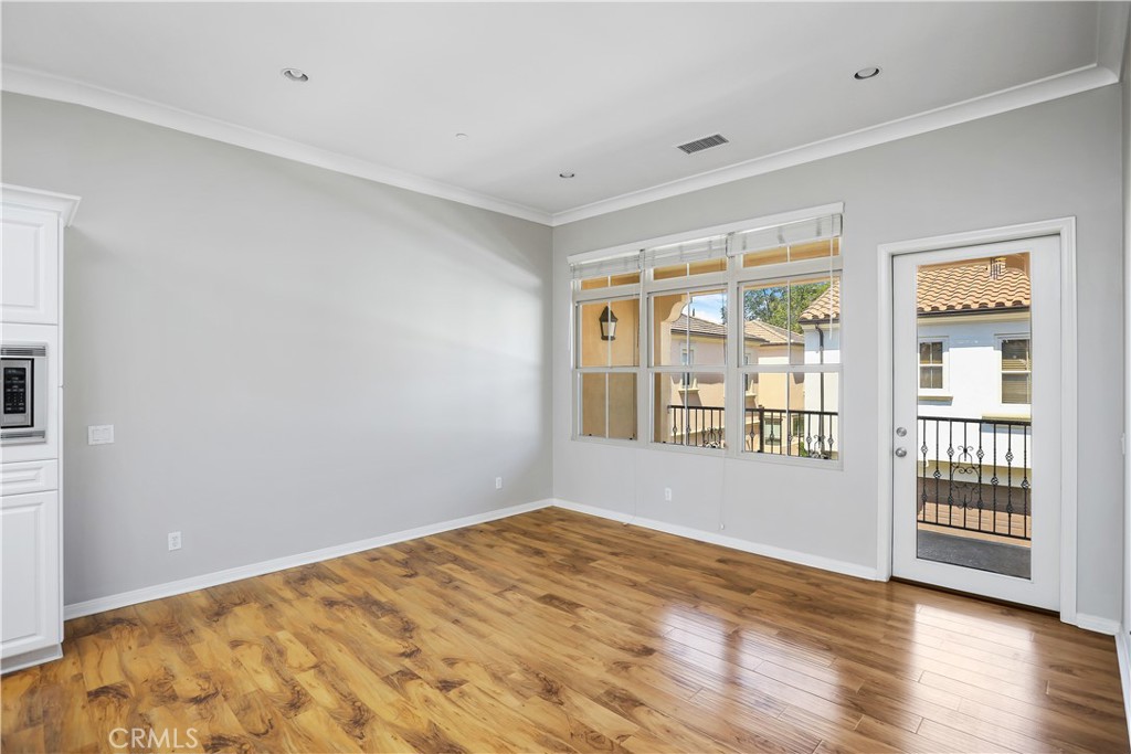 10 Nature Irvine, CA 92620 - Photo 10 of 27 a view of an empty room with wooden floor and a window