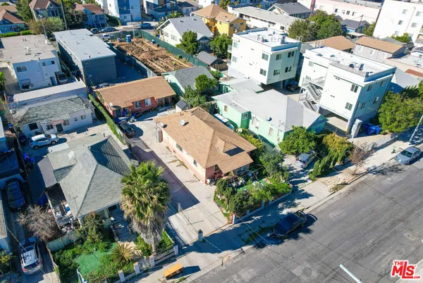 an aerial view of residential houses with outdoor space