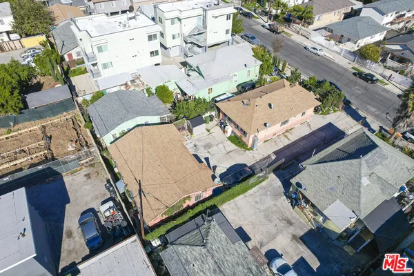 an aerial view of a house with a garden and large trees