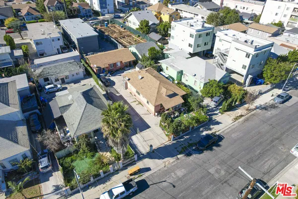an aerial view of multiple houses with yard