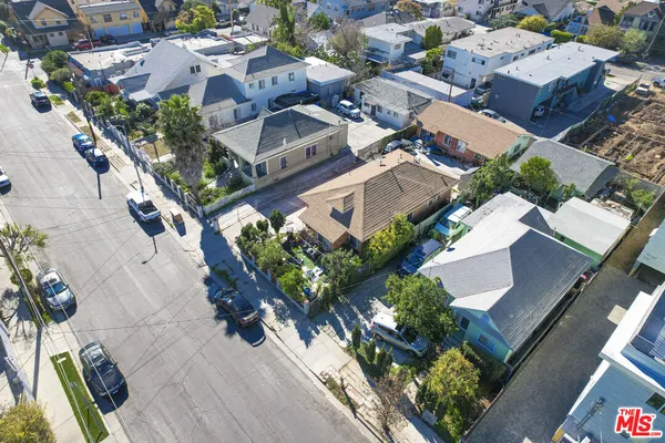 an aerial view of residential houses with outdoor space