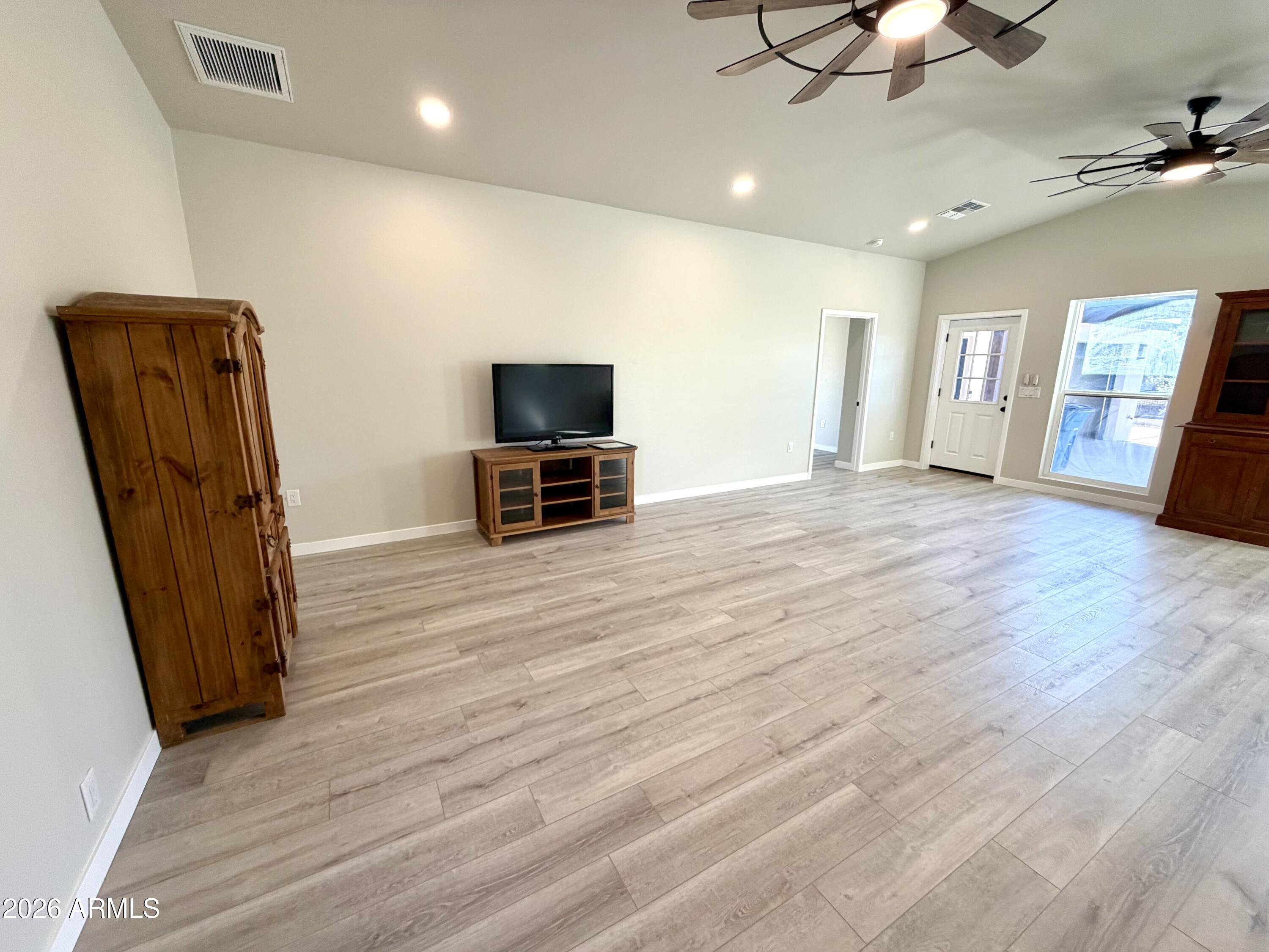 1165 North Mountain View Road Apache Junction, AZ 85119 - Photo 8 of 29 a view of room with window and wooden floor