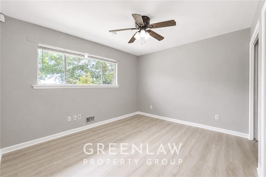 3605 Flat Shoals Road Atlanta, GA 30349 - Photo 25 of 35 a view of a big room with wooden floor and windows
