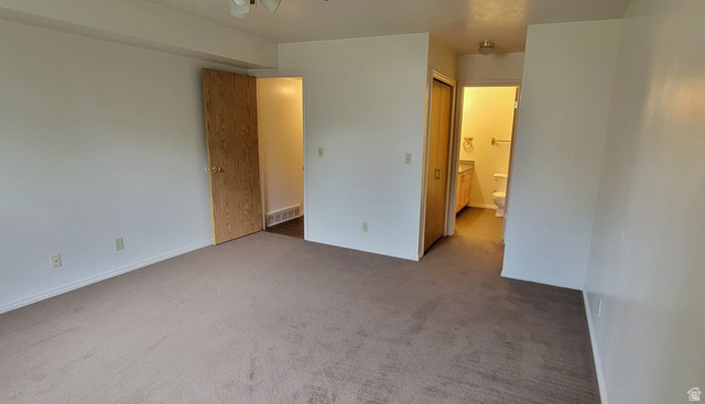 190 West 700 North Logan, UT 84321 - Photo 45 of 51 Unfurnished bedroom with carpet flooring, a closet, and connected bathroom
