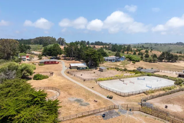 a dining room with furniture and large windows