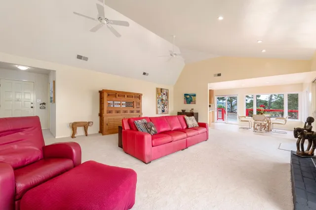a kitchen that has a lot of white cabinets and stainless steel appliances