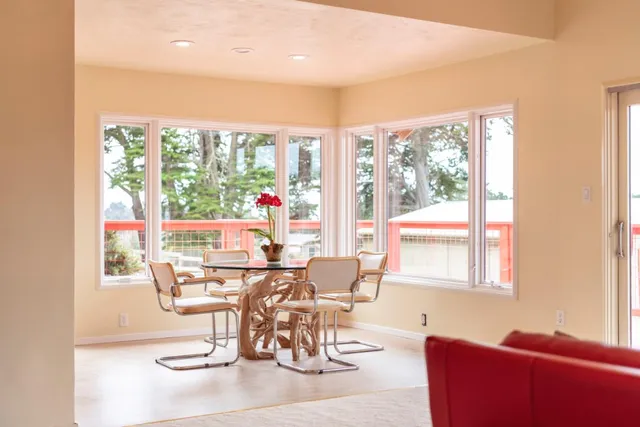 a view of a hallway with wooden floor and windows