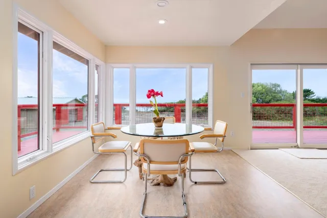 a view of a hallway with windows and chandelier