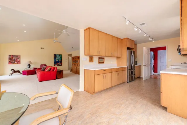 a spacious bedroom with a bed and a painting on the wall