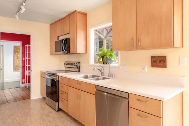 a spacious bedroom with a bed and a chandelier