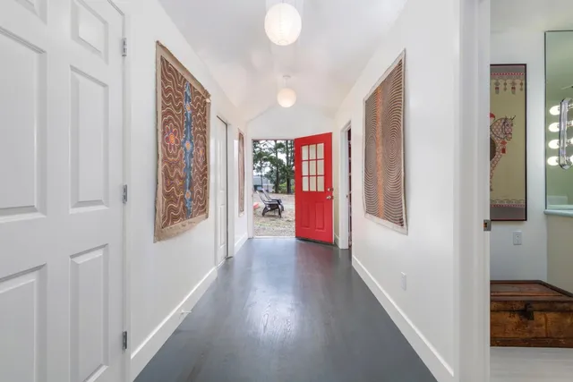 a bathroom with a sink a mirror and a potted plant