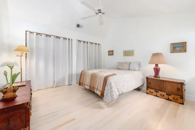 a bed room with a bed and a large window