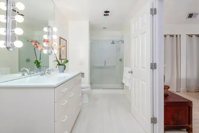 a spacious bedroom with a large bed and a large window