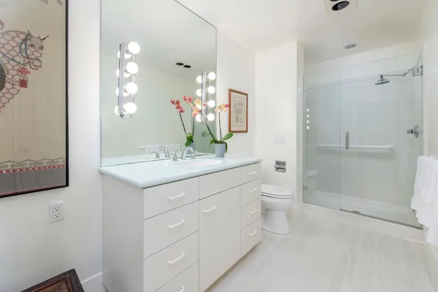 a spacious bedroom with a bed and dresser