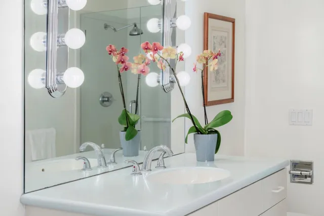 a bedroom with a bed and dresser with mirror