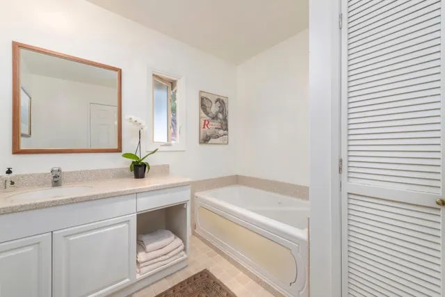 a white house with a wooden floor and yard in the back