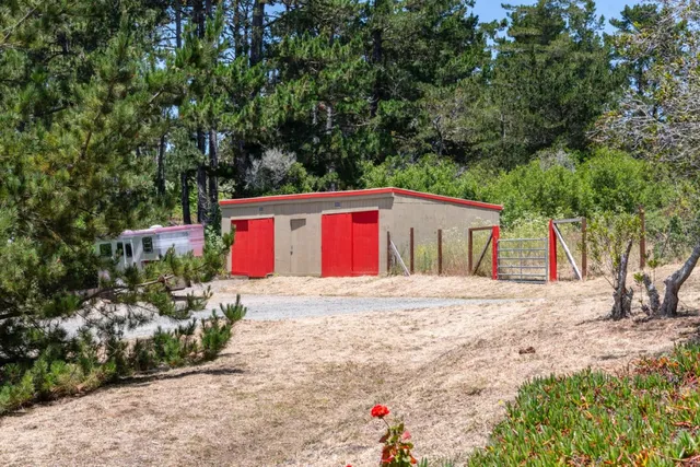 a view of a park with iron fence