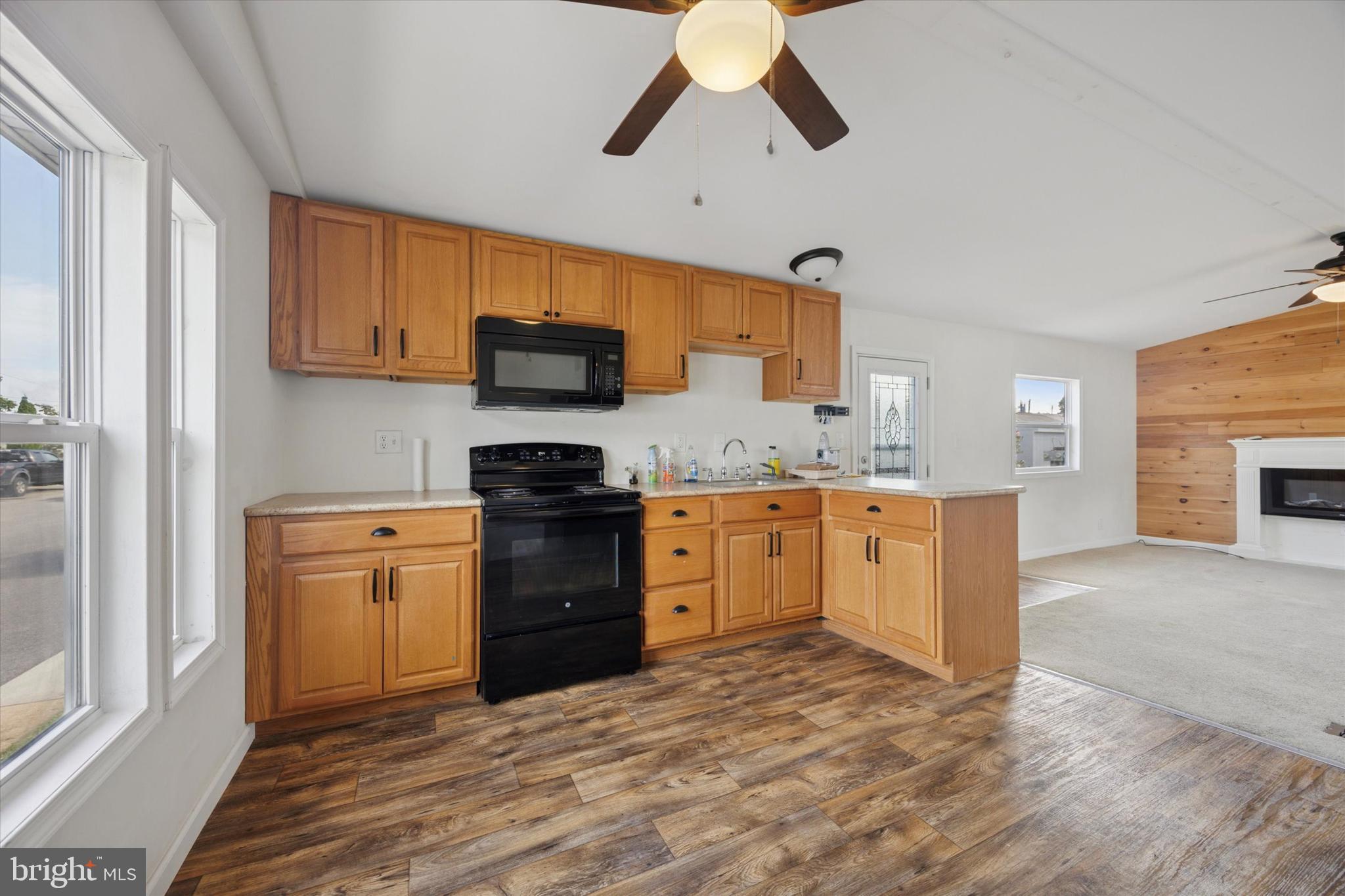 326 Delta Road Wilmington, DE 19810 - Photo 2 of 17 a kitchen with a stove refrigerator sink and microwave