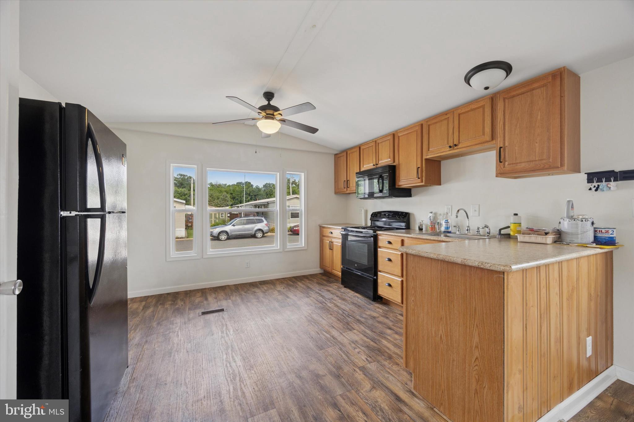 326 Delta Road Wilmington, DE 19810 - Photo 6 of 17 a kitchen with stainless steel appliances granite countertop a refrigerator a sink dishwasher a stove with wooden floor and cabinets