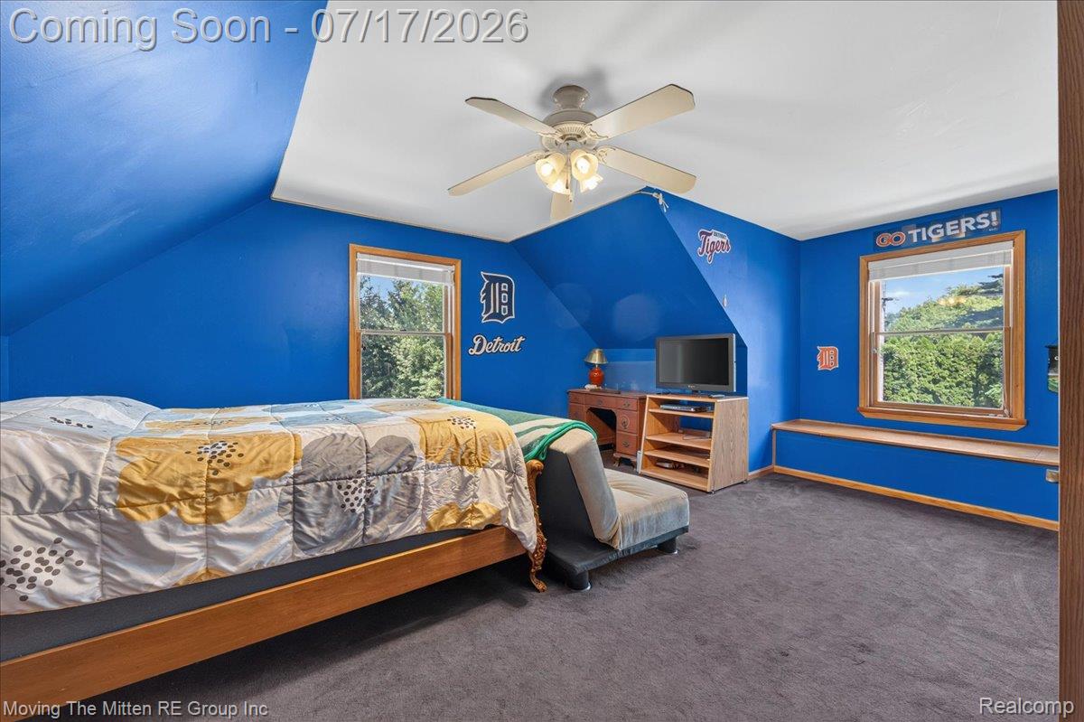 40162 Alden Road Belleville, MI 48111 - Photo 36 of 67 Carpeted room featuring sloped ceilings, two windows with wood trim, a built-in window bench, and a ceiling fan