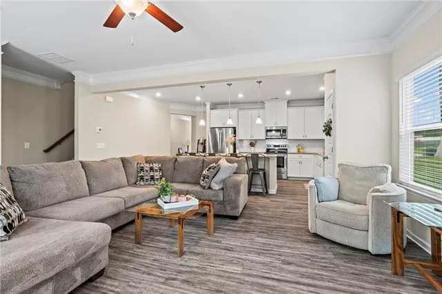 a living room with furniture and kitchen view