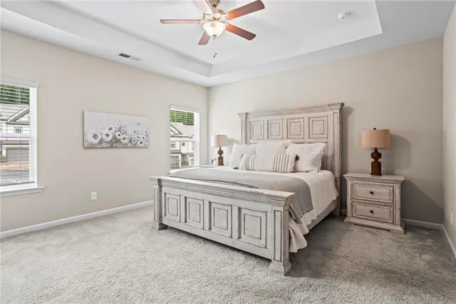 a spacious bedroom with a bed and a window