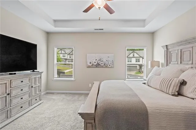 a bedroom with a large bed and a flat screen tv