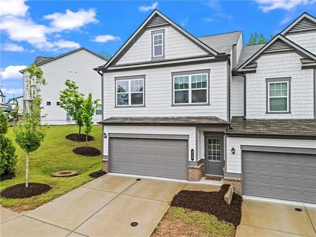 a front view of a house with garden
